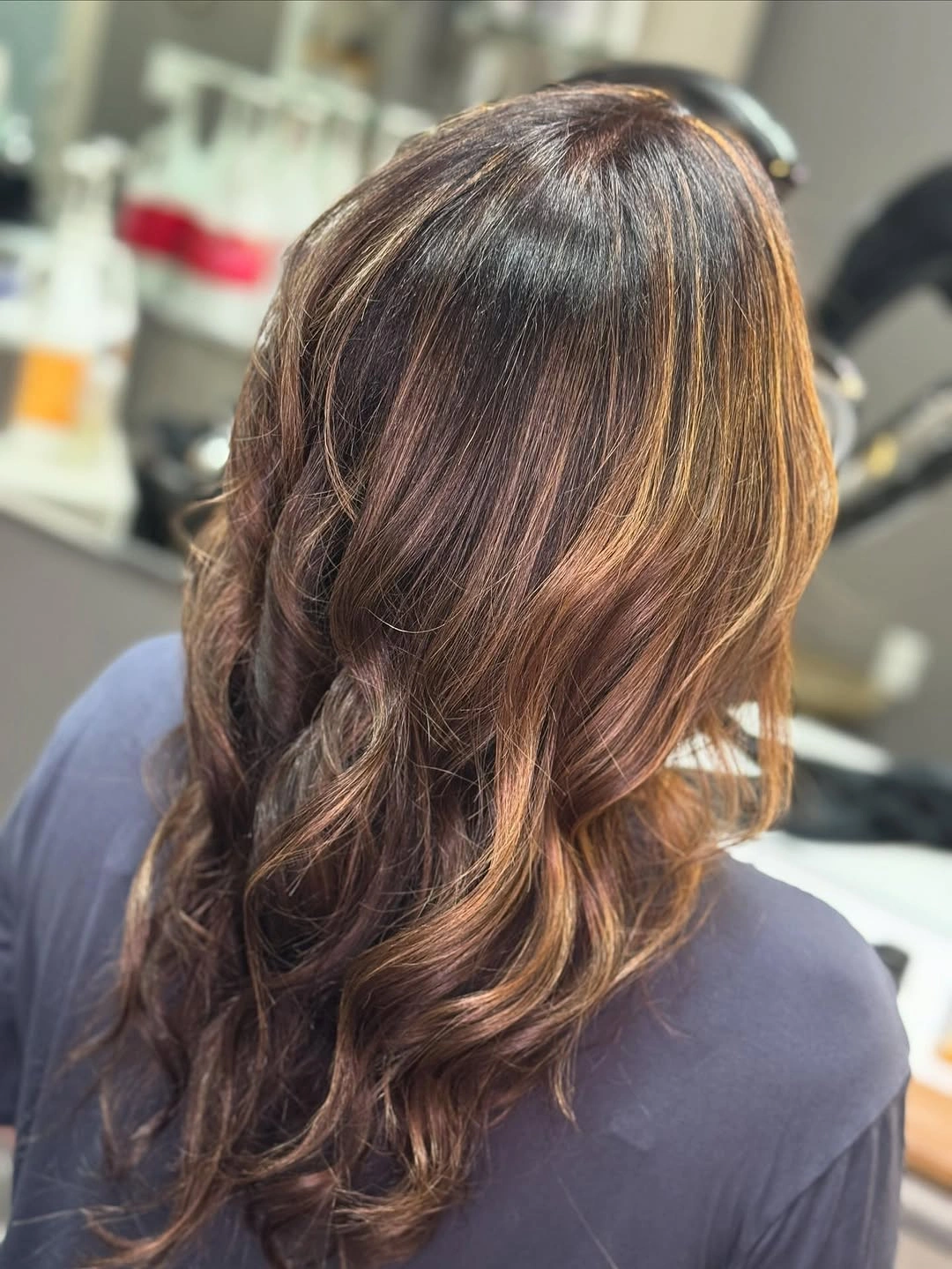 hair lowlights color ideas and inspiration Warm Brunette Waves With Golden Face Framing