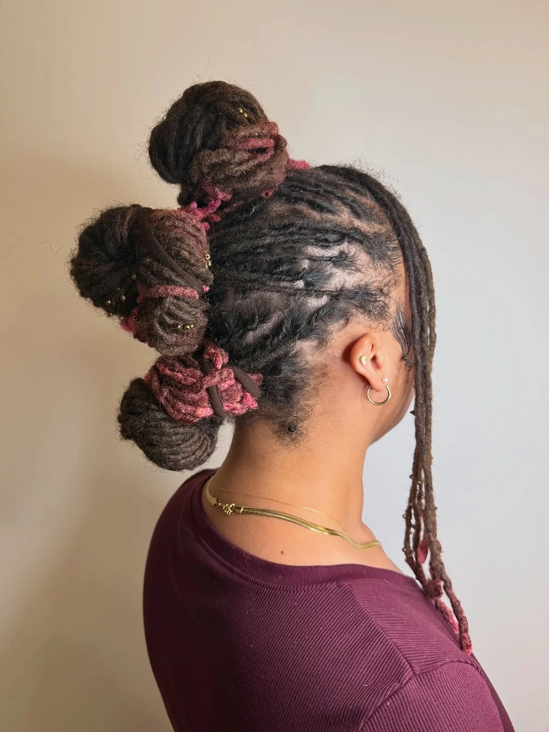 locs hairstyles for black women Creative Triple Bun Loc Style With Artistic Detail
