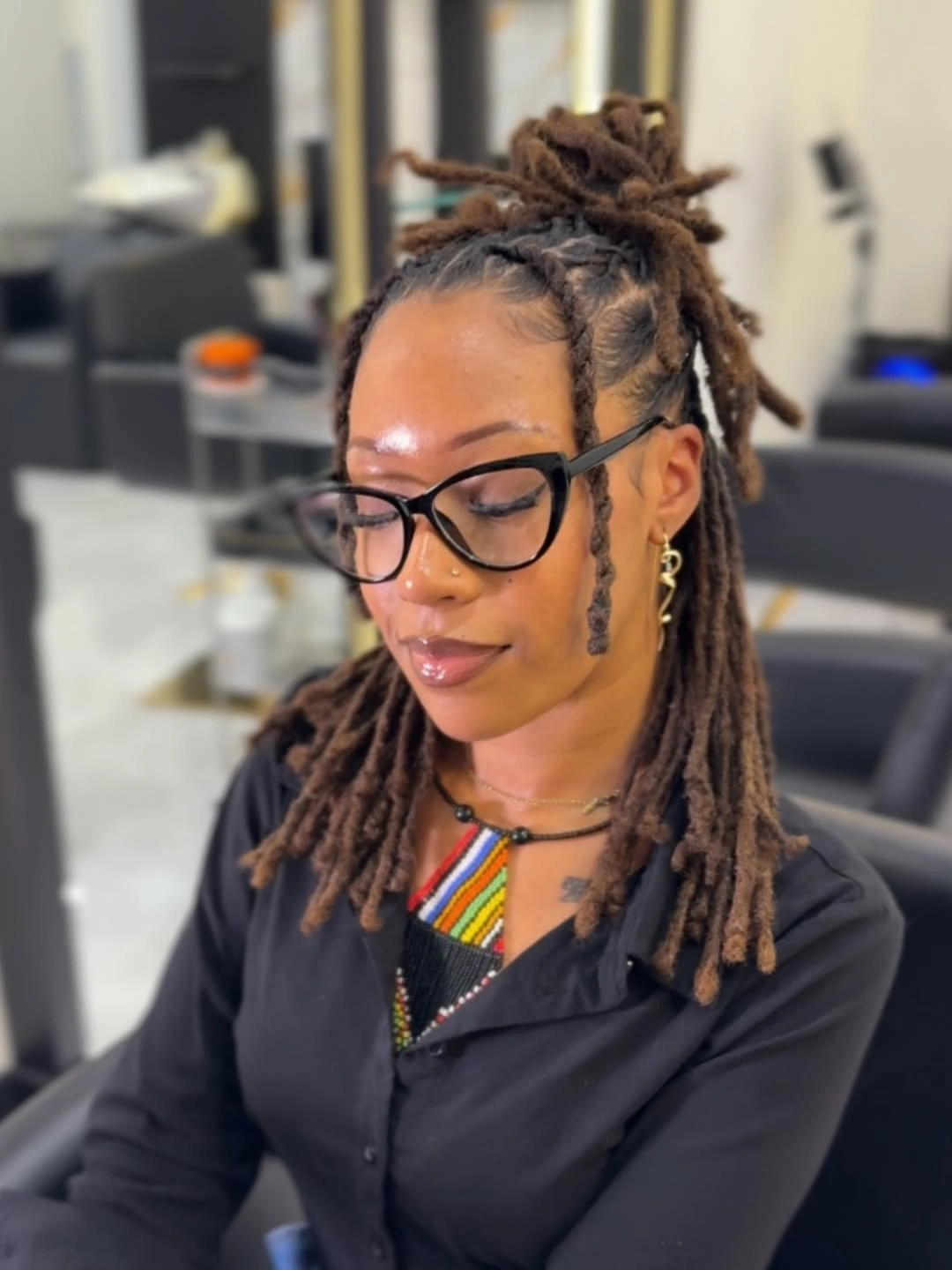 locs hairstyles for black women Half-Up Loc Bun With a Modern Edge