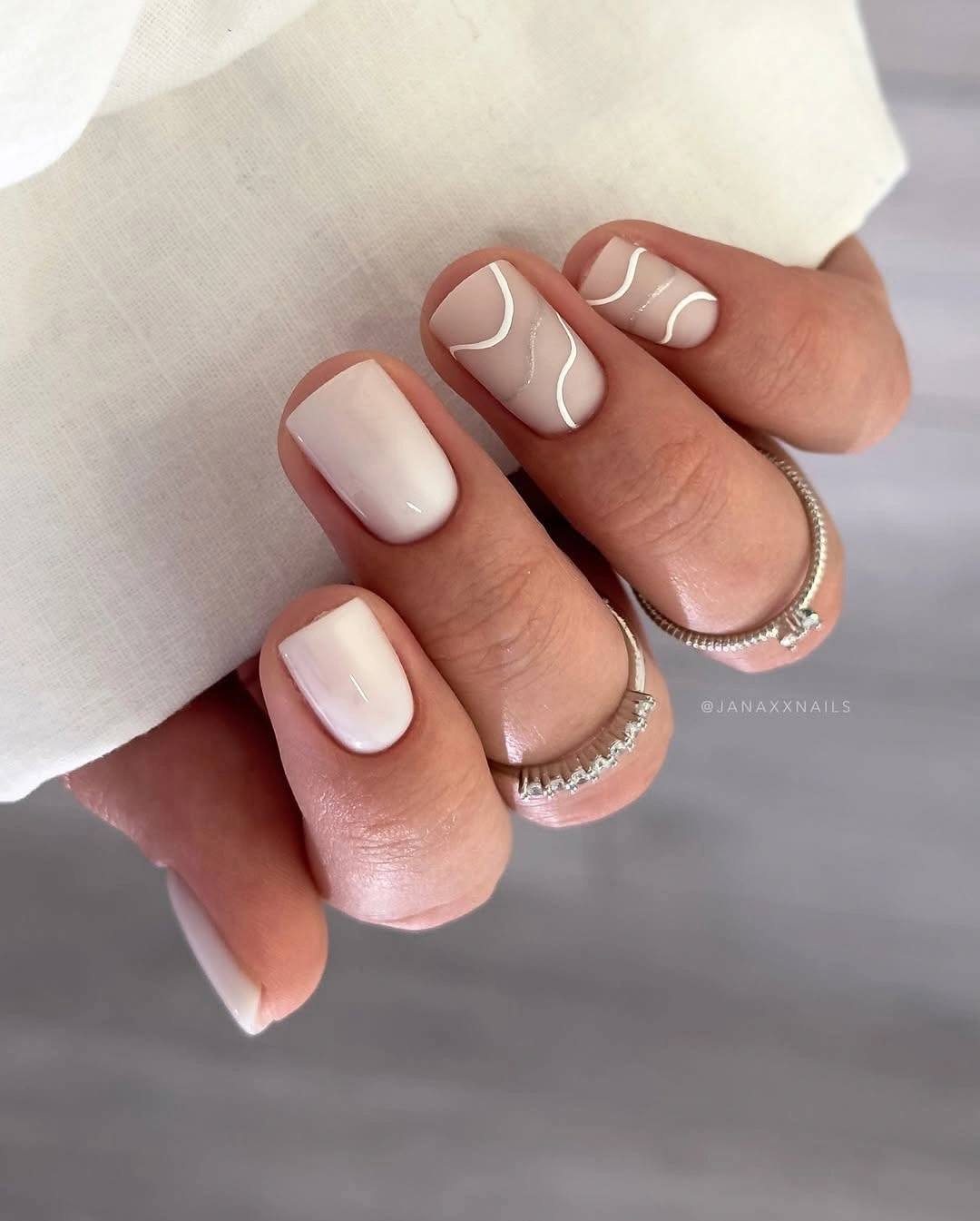 September nail art ideas 2026 Cream Short Nails With Taupe Wave Lines