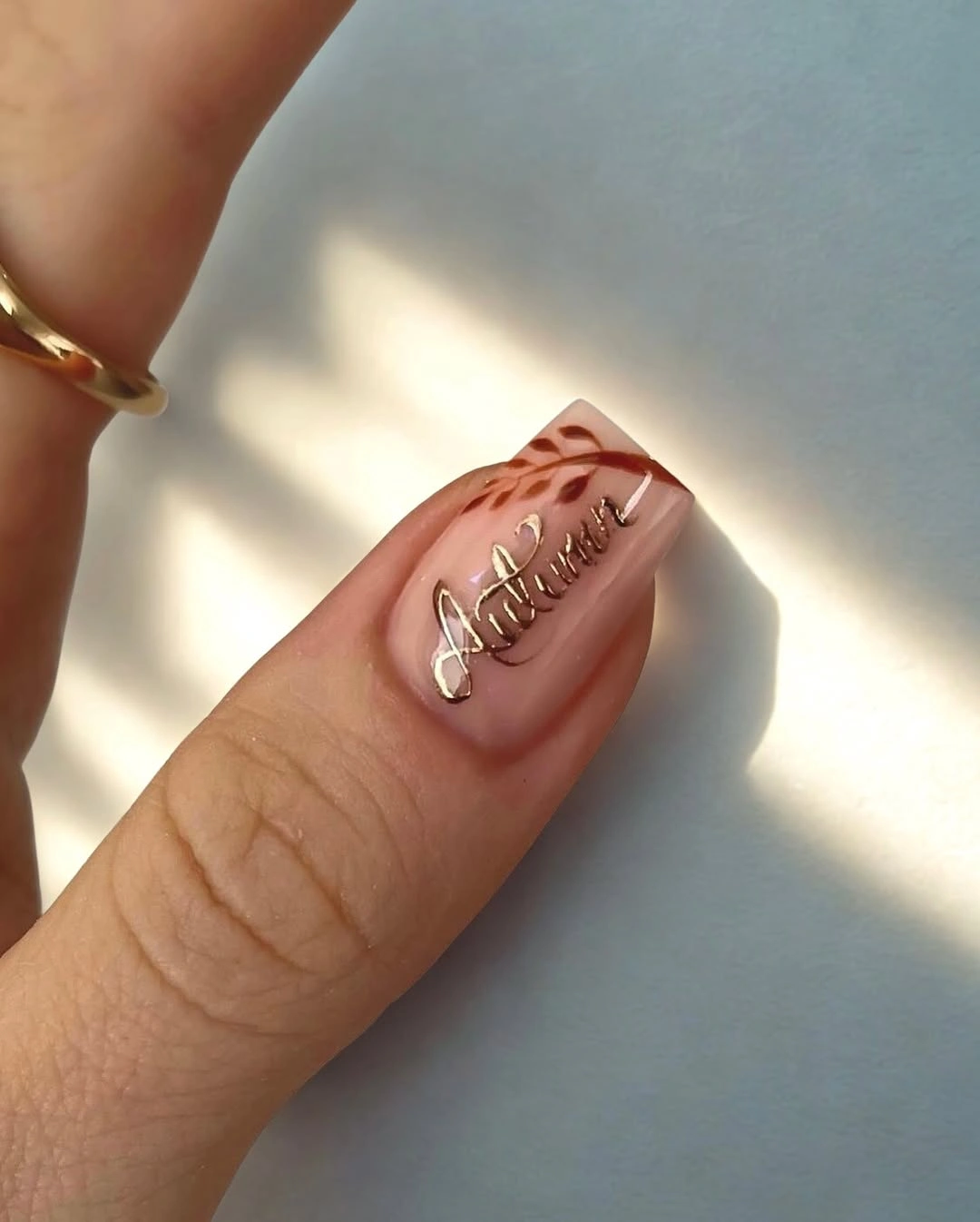 September nail designs 2026 Single Nude Nail With Raised Silver Script