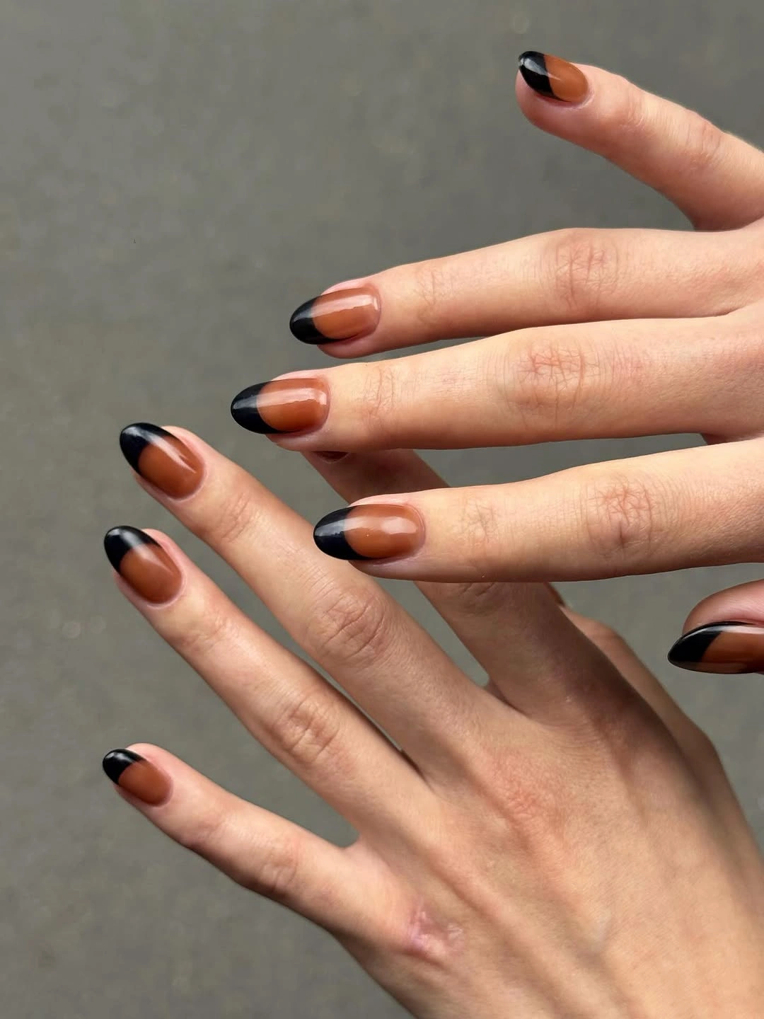September nails color 2026 Black Curved Tips Over Warm Nude