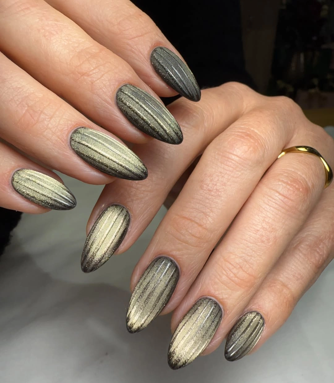 long almond nails in reflective metallic olive green