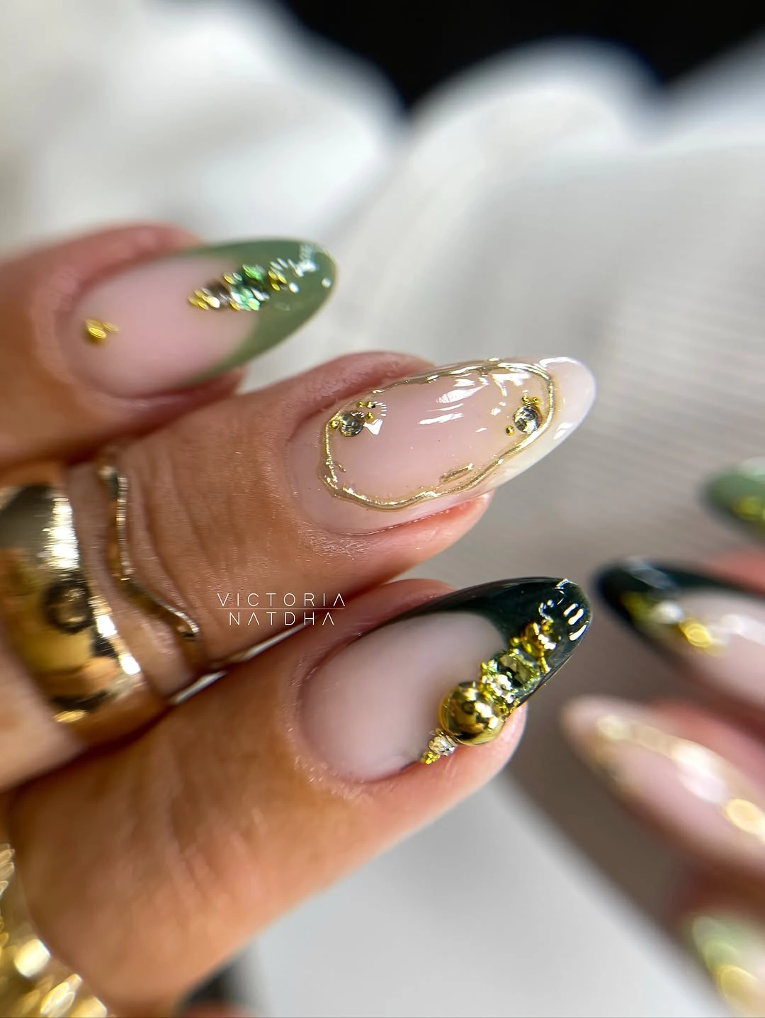 long almond sheer nails with green and gold French accents
