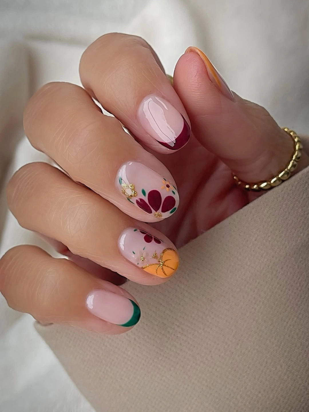 medium pink nails with small flowers and green tips