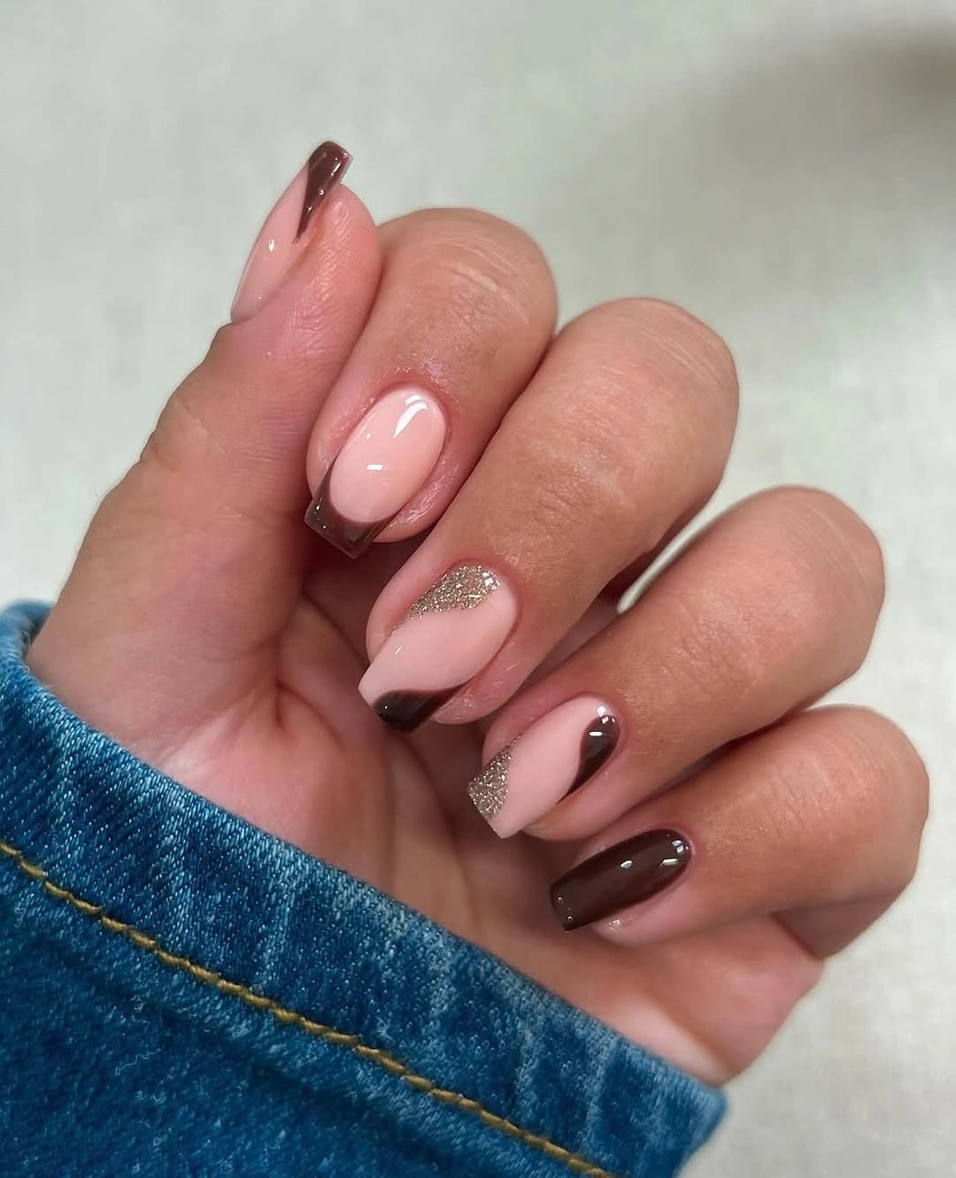 medium almond nails with mauve brown and glitter tips