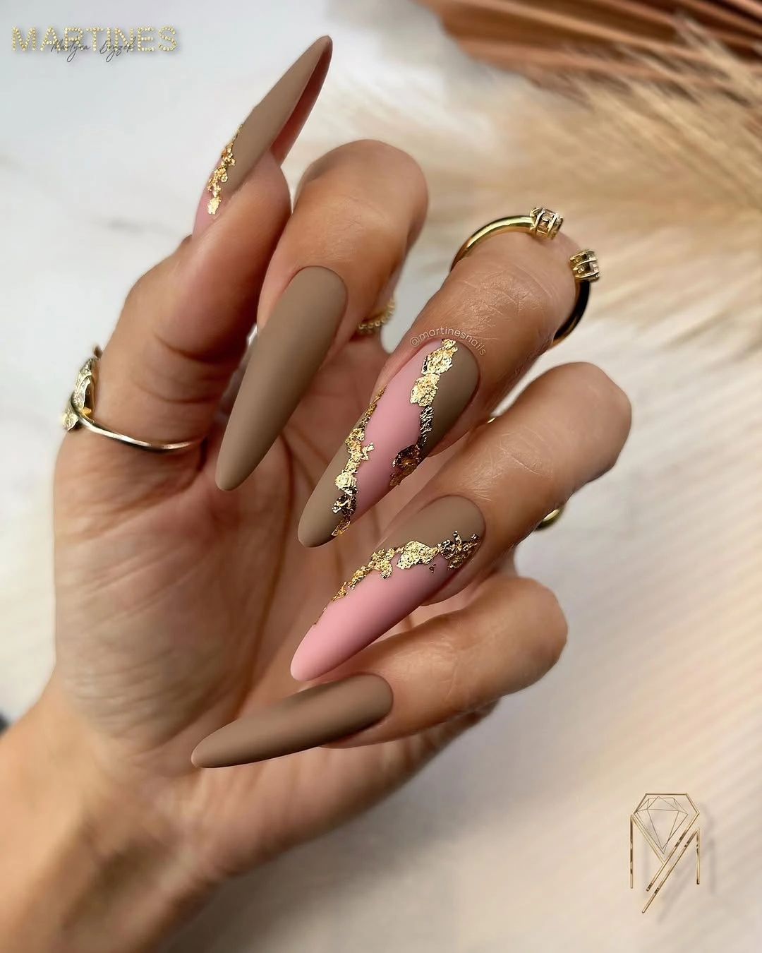 long pointed taupe blush nails with gold accents