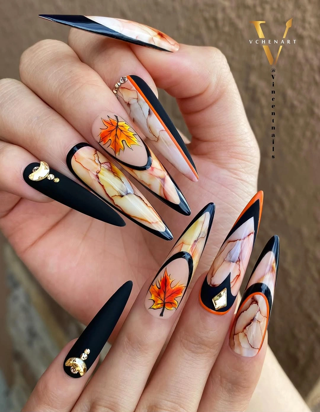 long pointed black cream nails with orange floral art