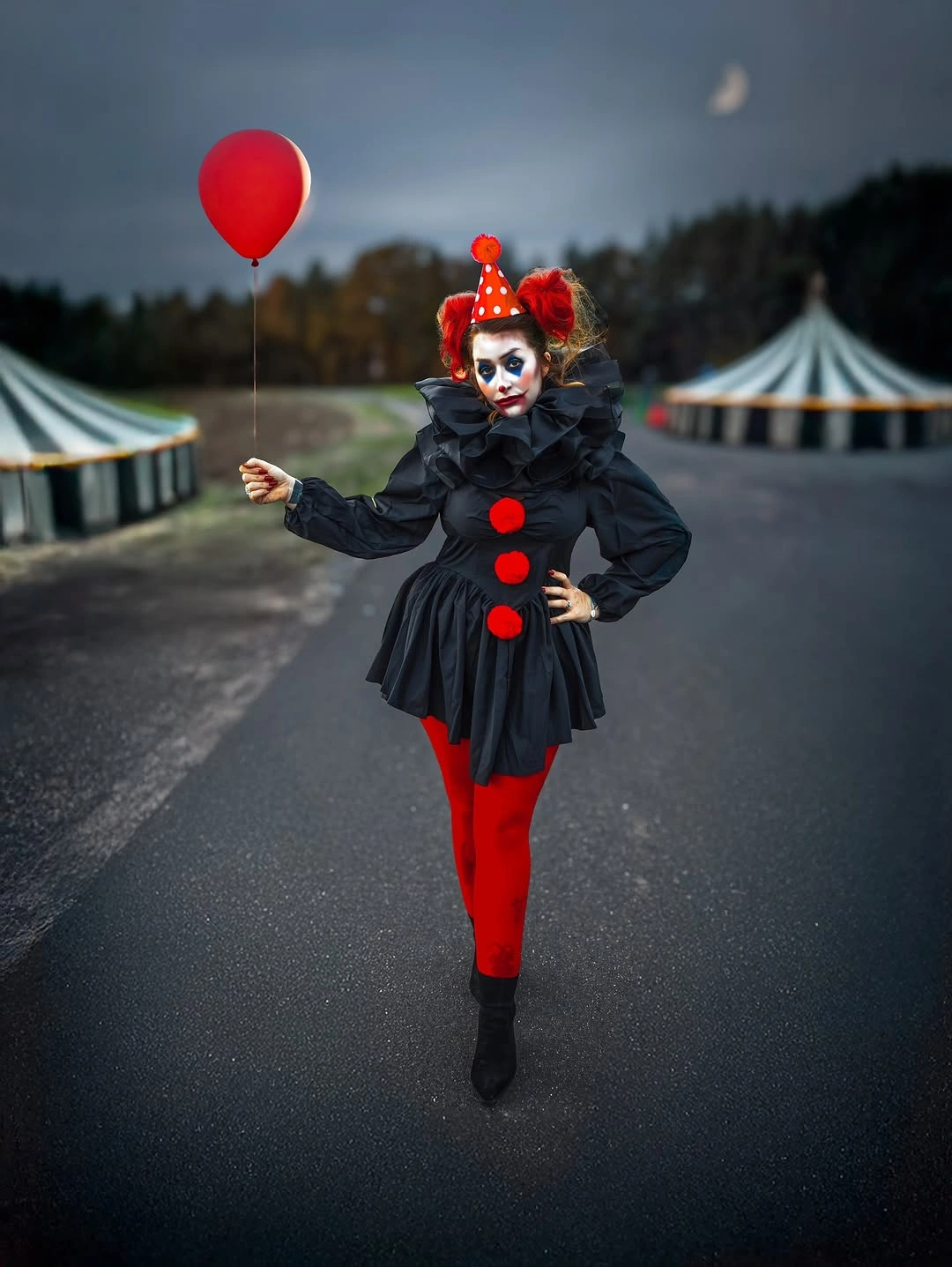 Black ruffled clown costume with red tights and balloon