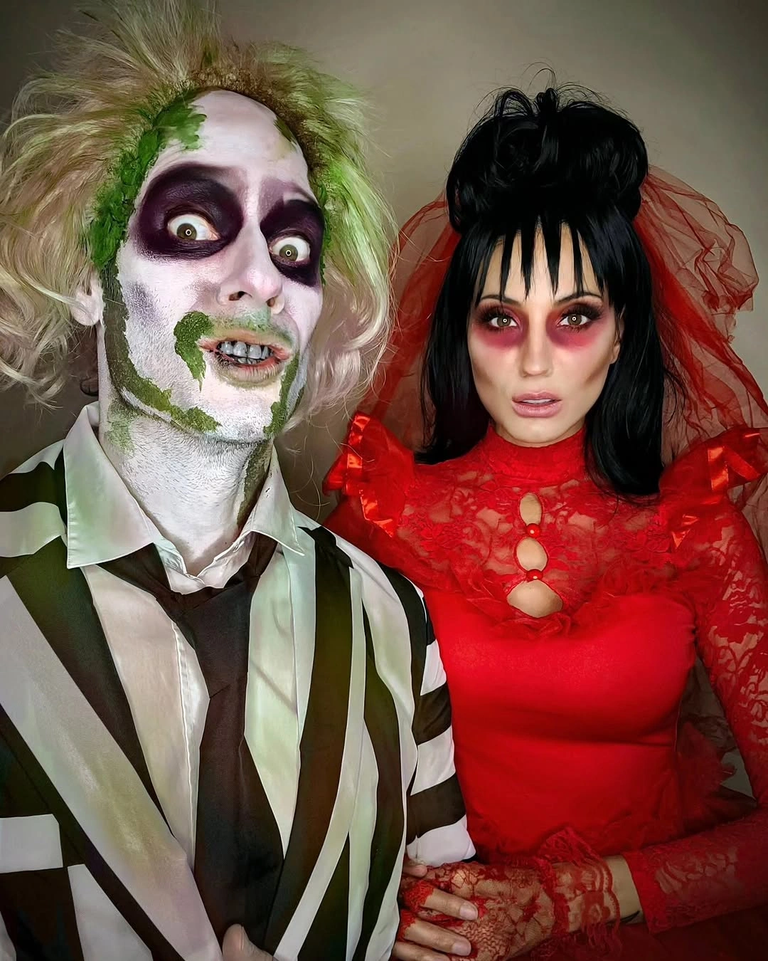 Striped suit and red lace dress as coordinated Halloween couple costumes