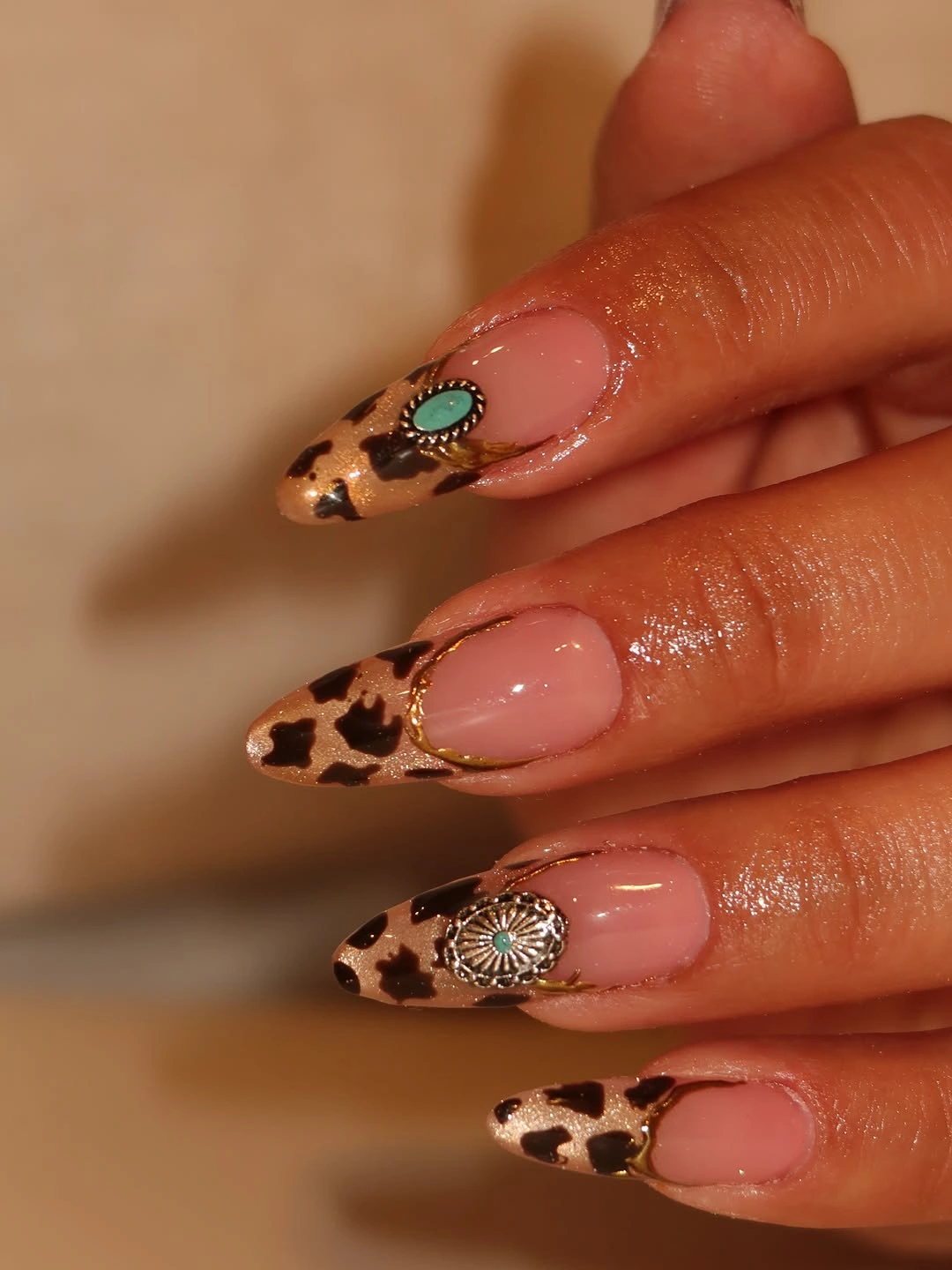 Pink almond nails with leopard brown tips and gold edging