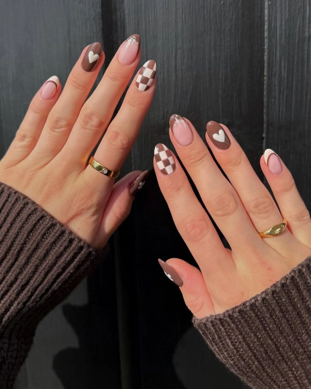 Brown French almond nails with checkerboard and swirl accents