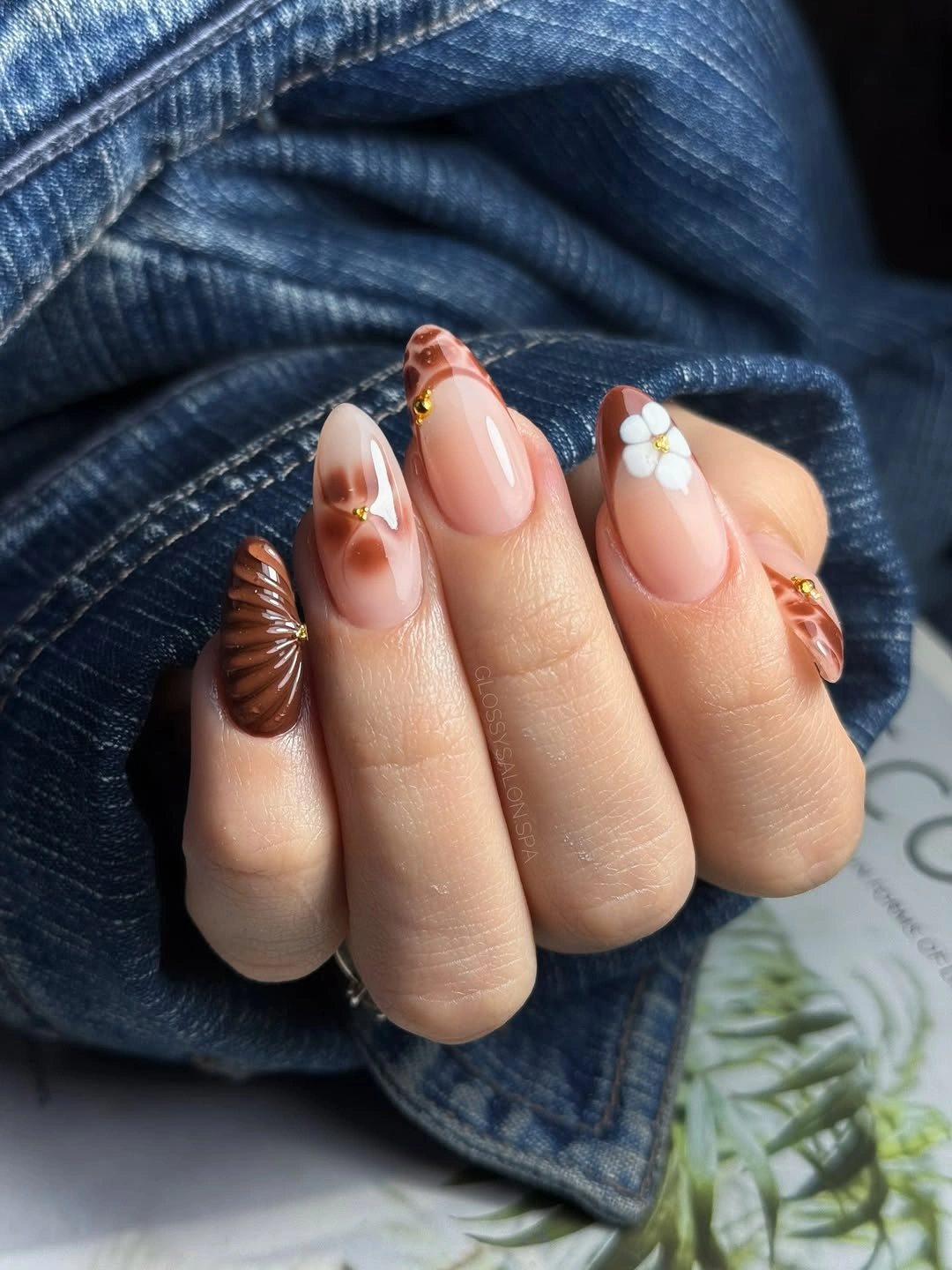 Pink almond nails with orange florals and a white flower accent