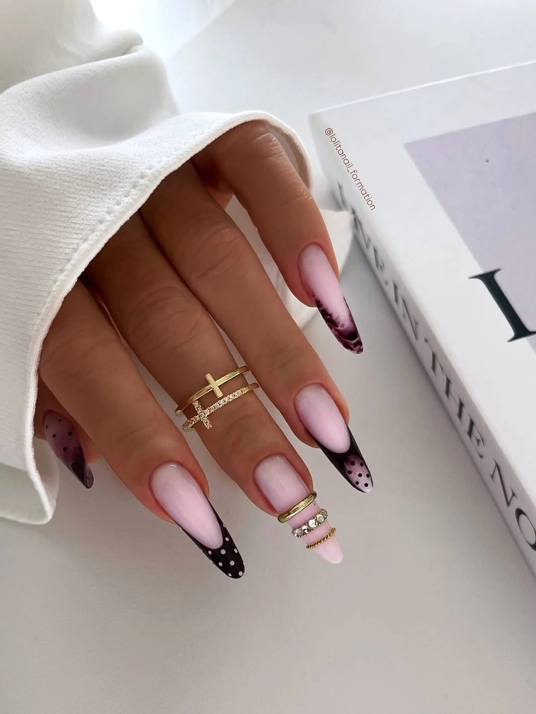Pink almond nails with brown French tips and dark spots