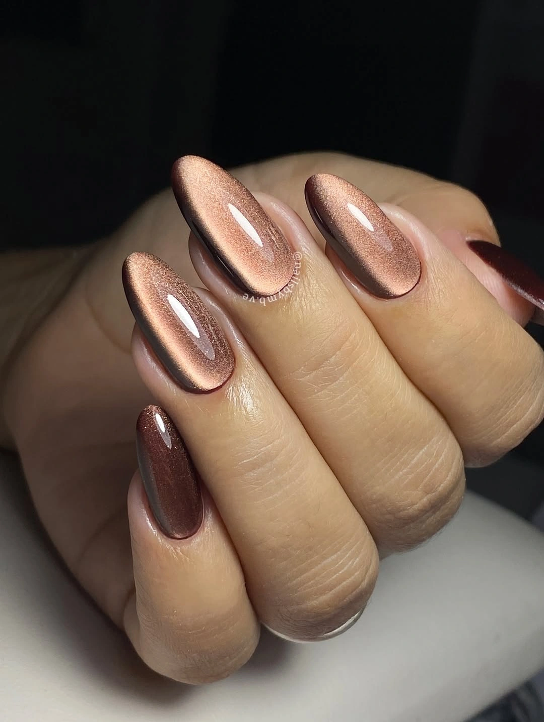 Short oval nails with reflective rose brown chrome finish