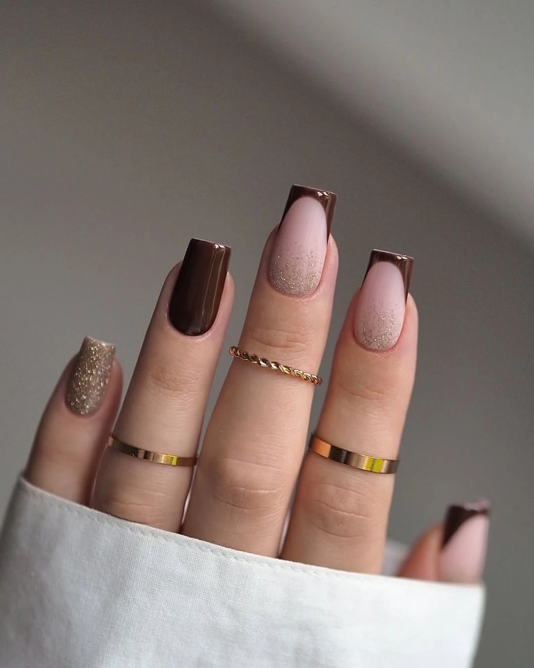Mauve shimmer almond nails with chocolate tips and gold accent