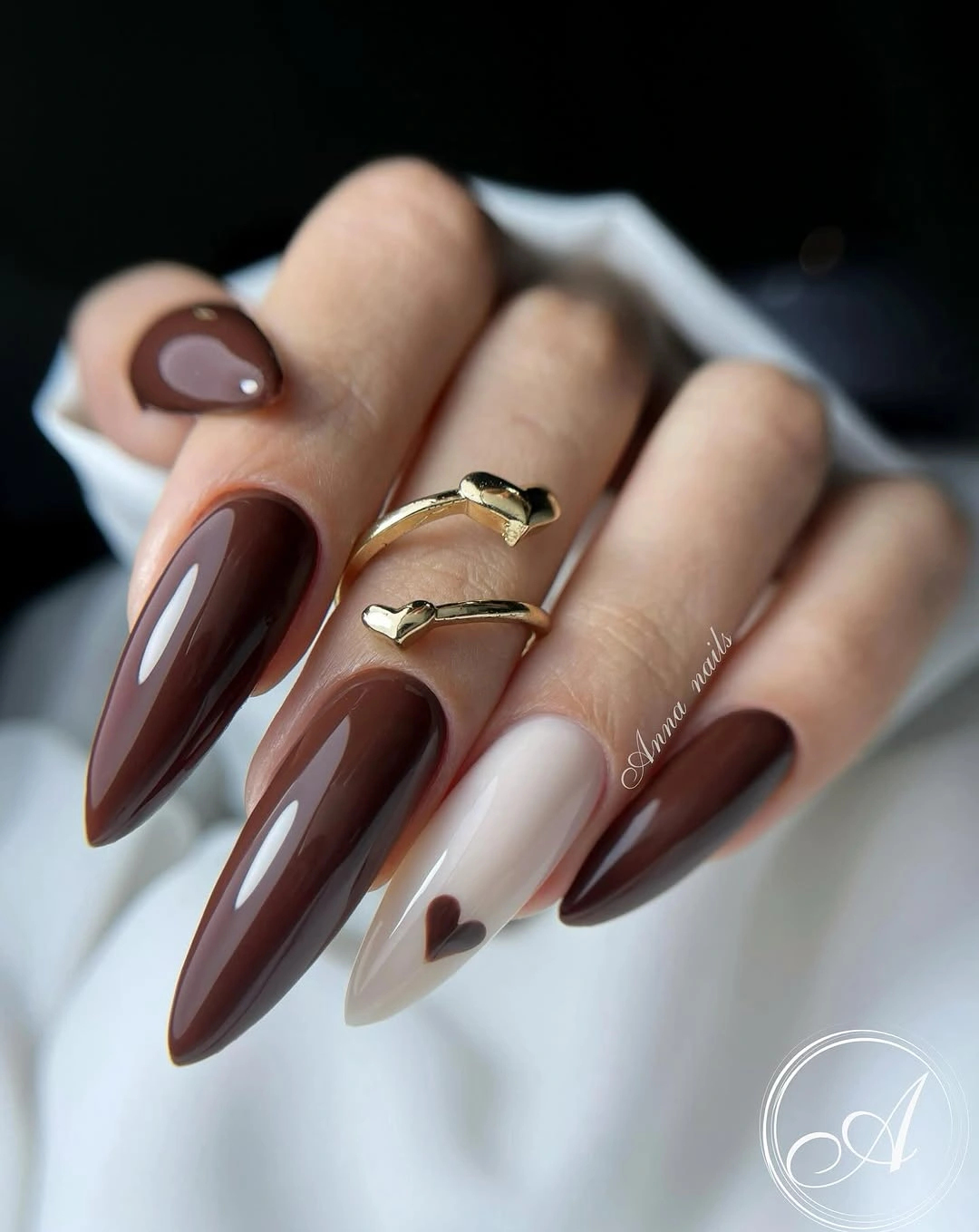 Deep brown stiletto nails with pale heart accent