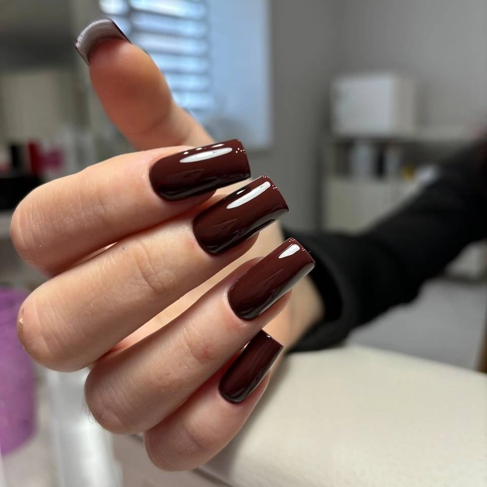 Long square nails in glossy burgundy brown