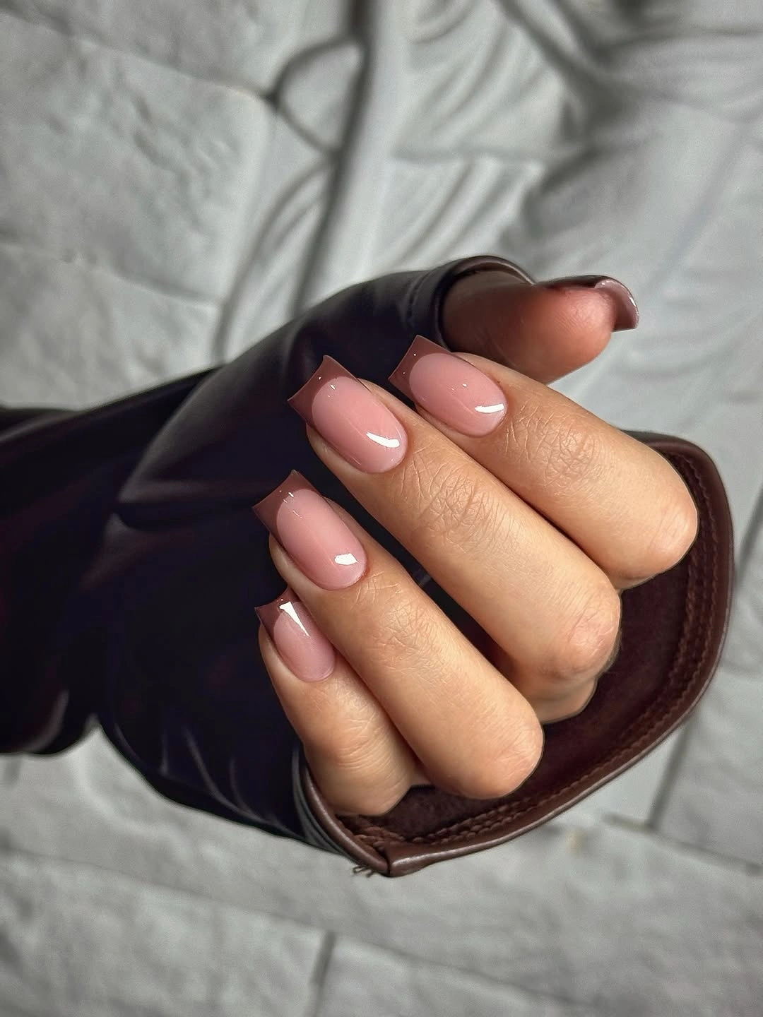Blush rounded nails with chocolate tips and dark accent