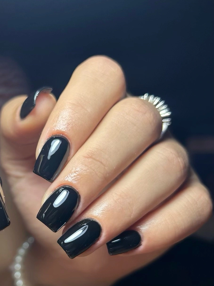 Deep navy almond nails with a thin silver border