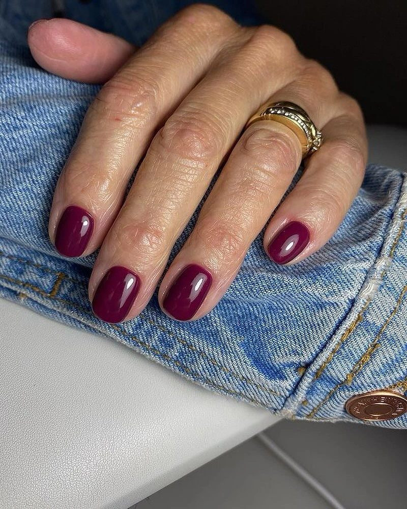 Black almond nails with pale botanical silhouette accents