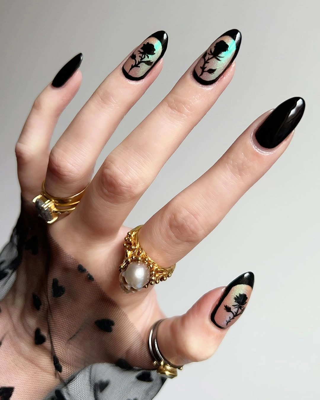 Black and deep red pointed nails with layered curved lines