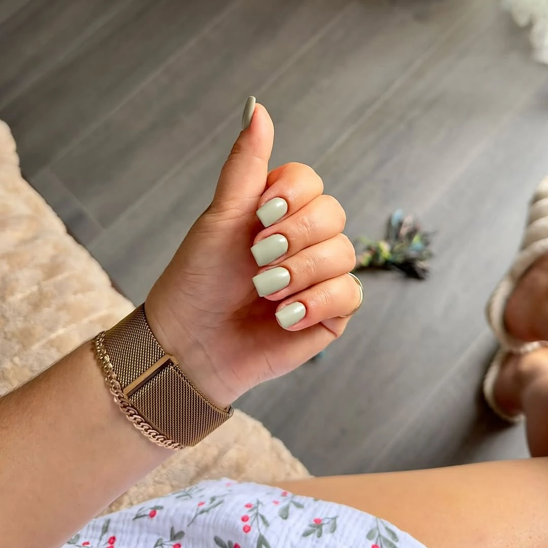 Pale mint green rounded nails in a solid glossy color