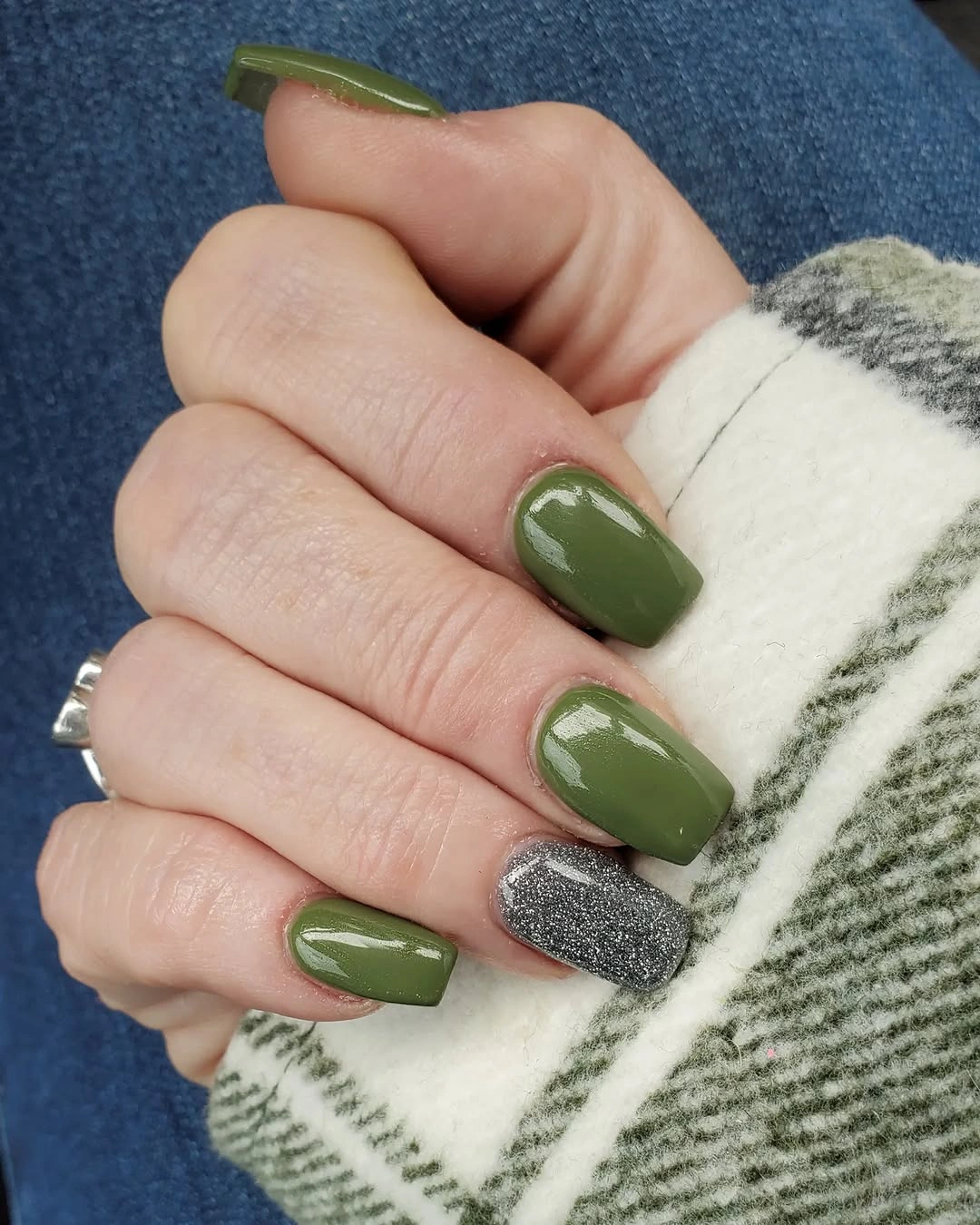 Muted olive square nails with one silver glitter accent