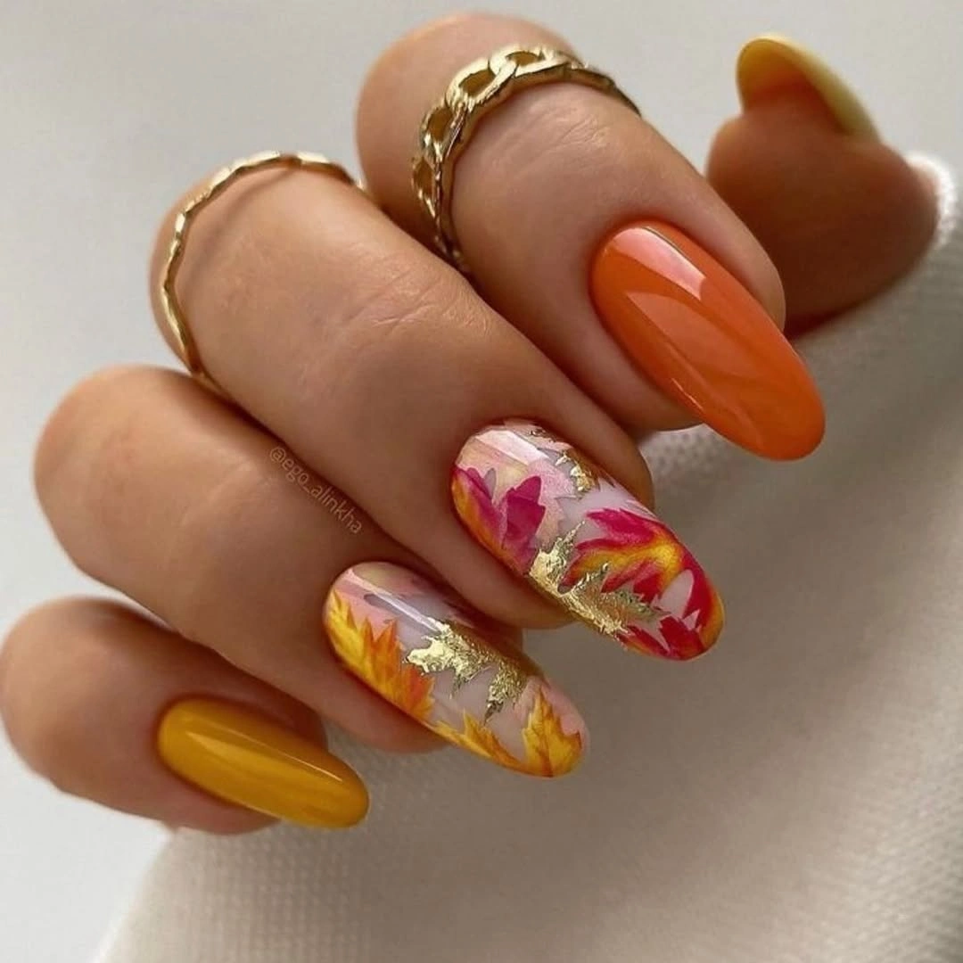 Mustard nails with orange pink and pale marbled accents