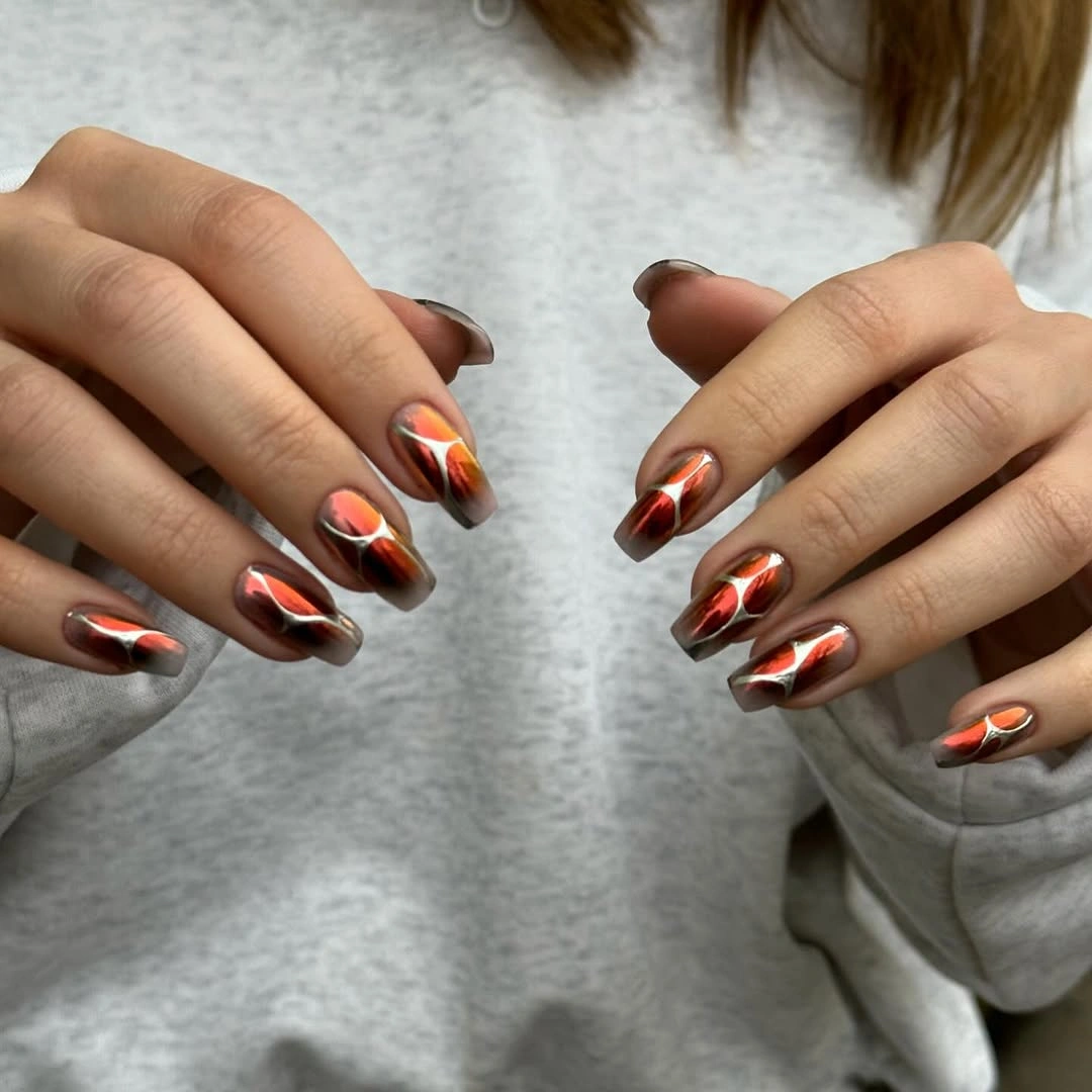 Sheer almond nails with copper red and smoky reflective accents