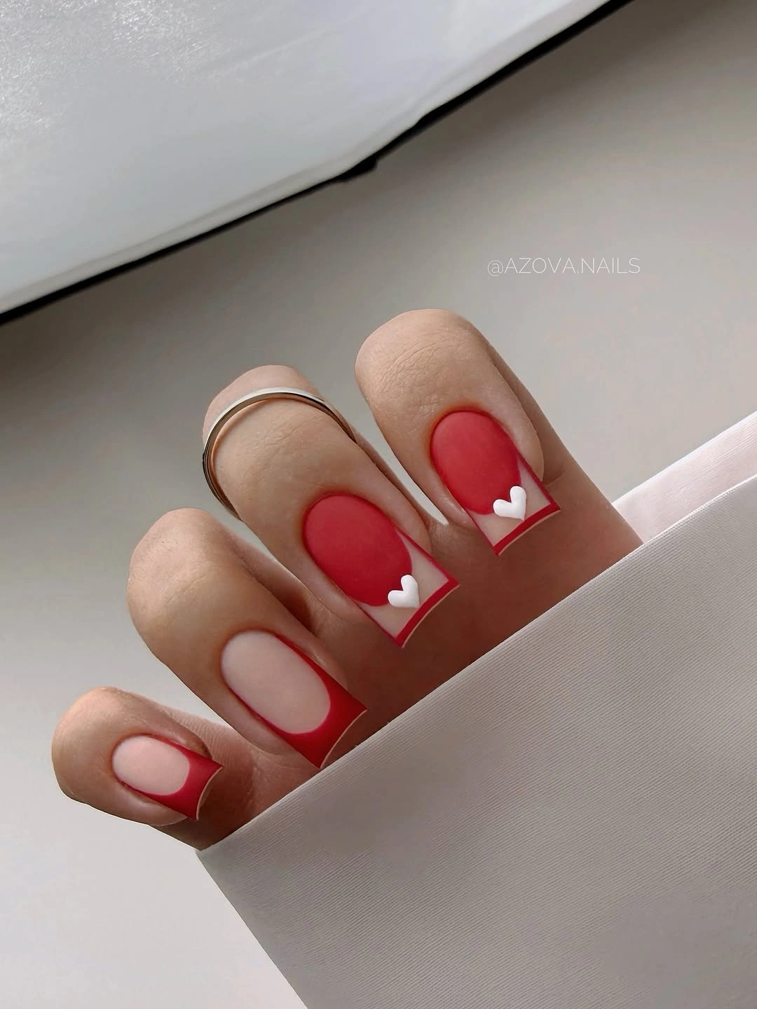 Red nude square nails with tiny white heart accents