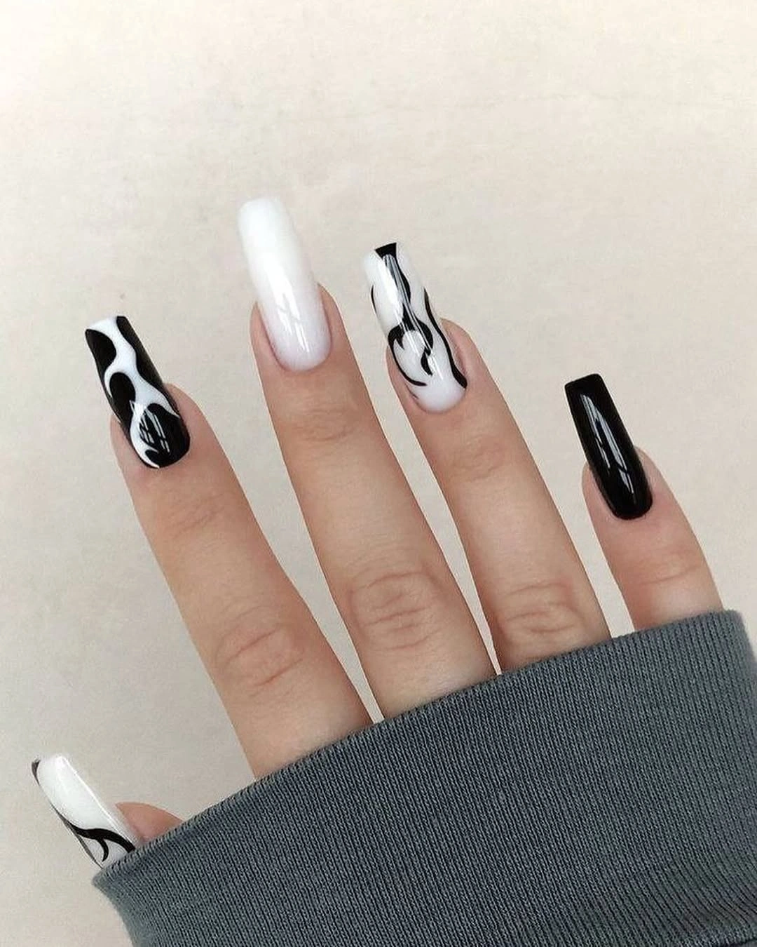Black white navy and orange graphic accent nails