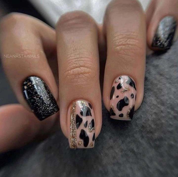 Black glitter nails with taupe leopard accent