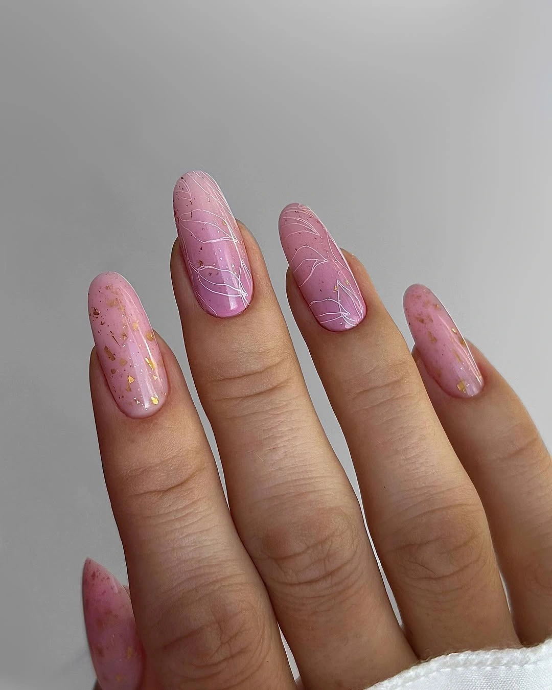 Translucent pink nails with fine white crackle lines