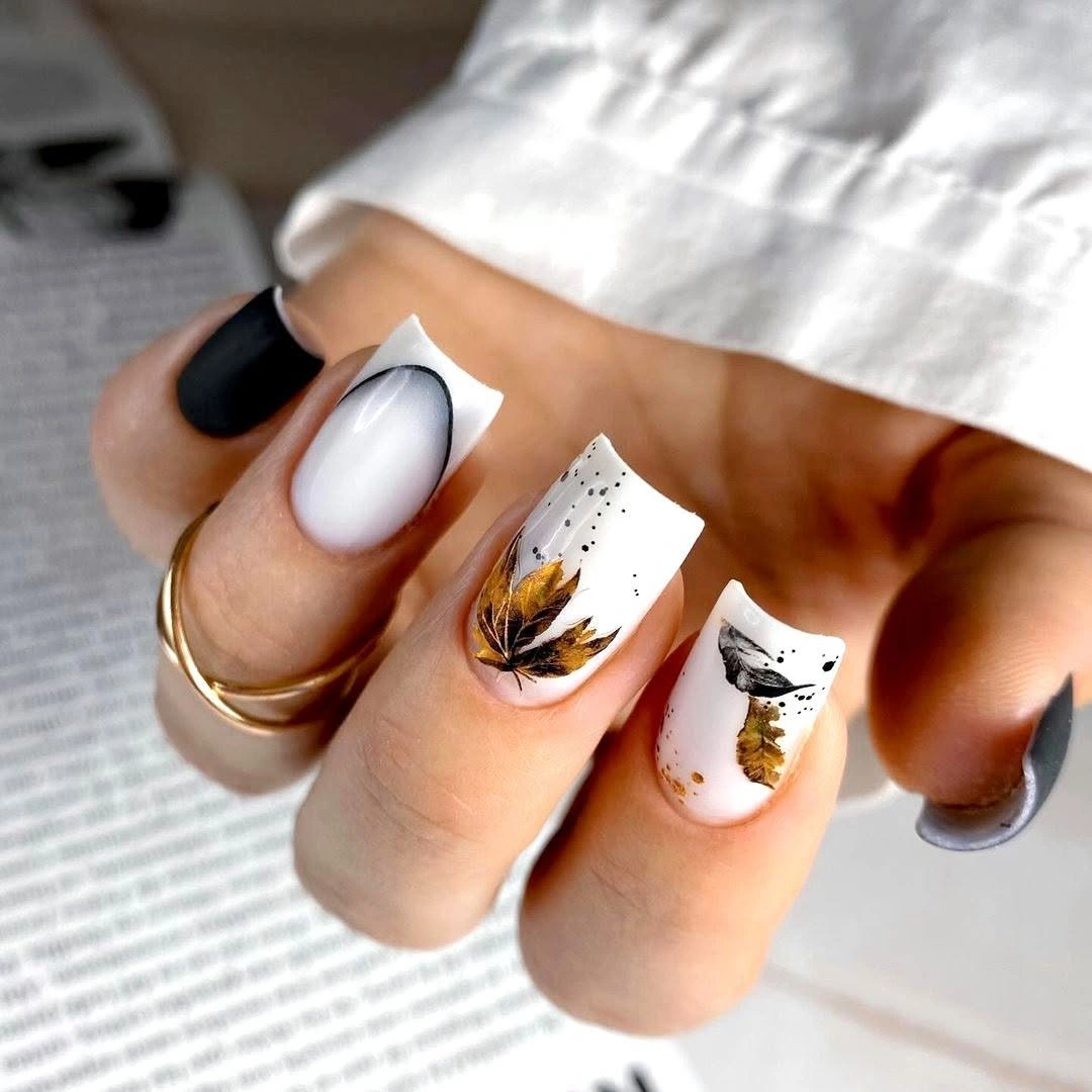 Yellow orange nails with floral motifs and gold foil