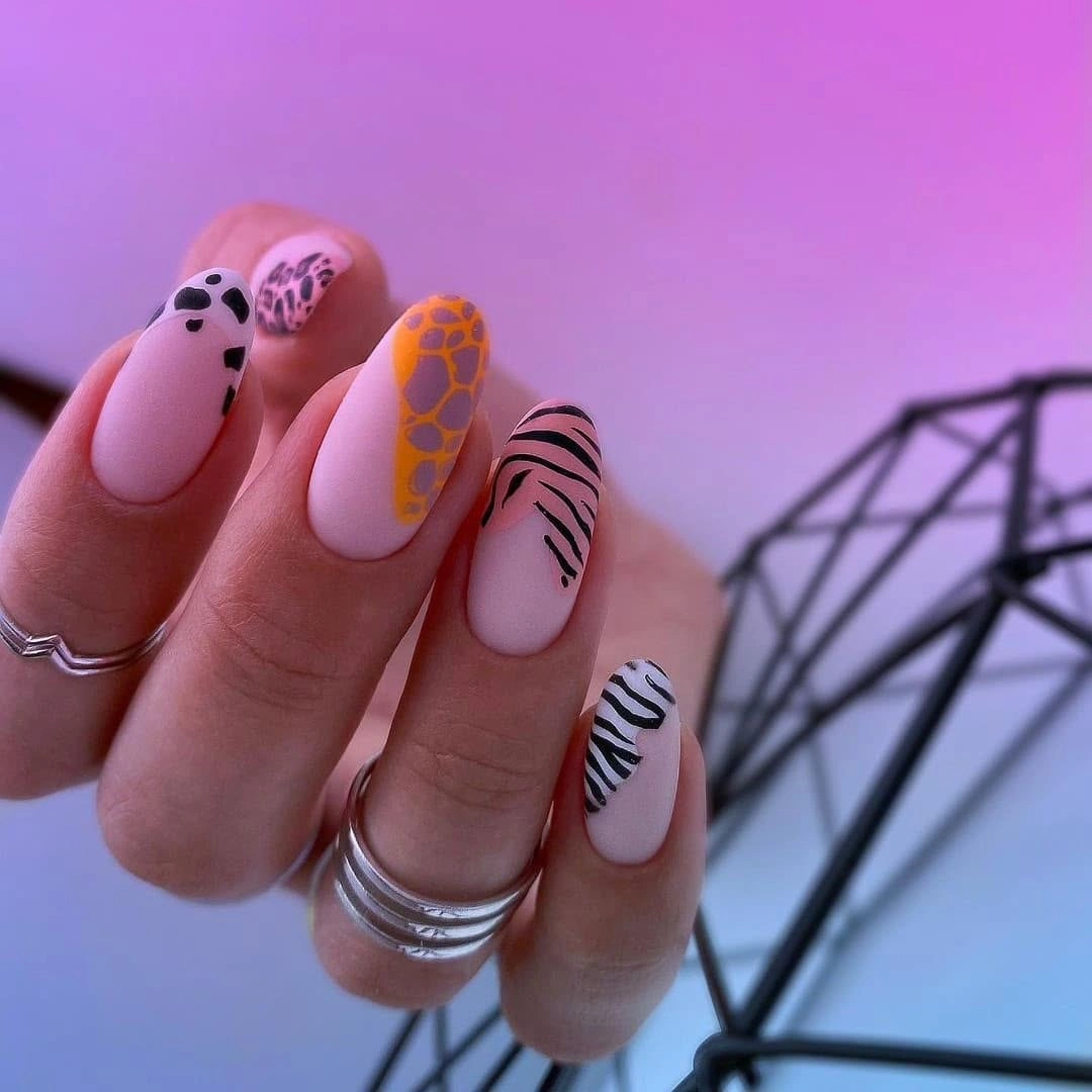 Long almond nails with leopard zebra and pink accents
