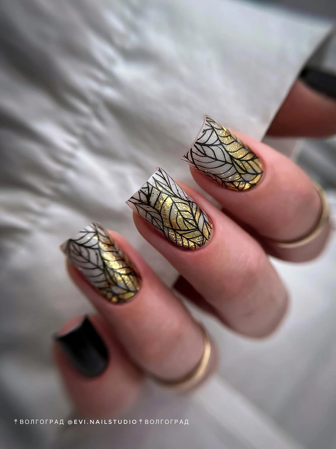 Black white nails with gold botanical accent details