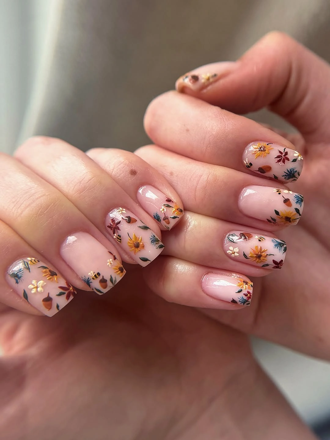 Short blush square nails with tiny autumn botanicals