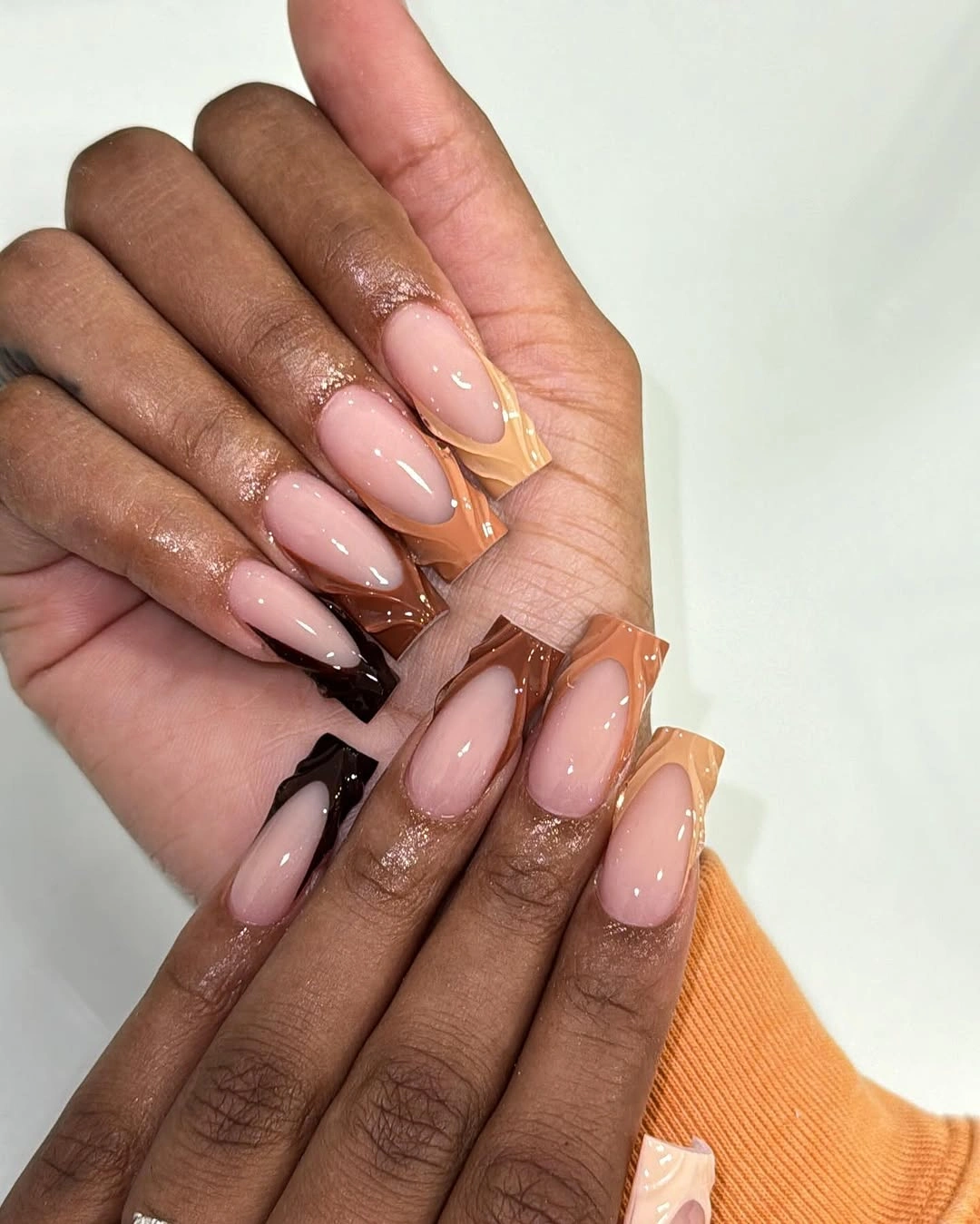 Pink almond nails with amber brown tips