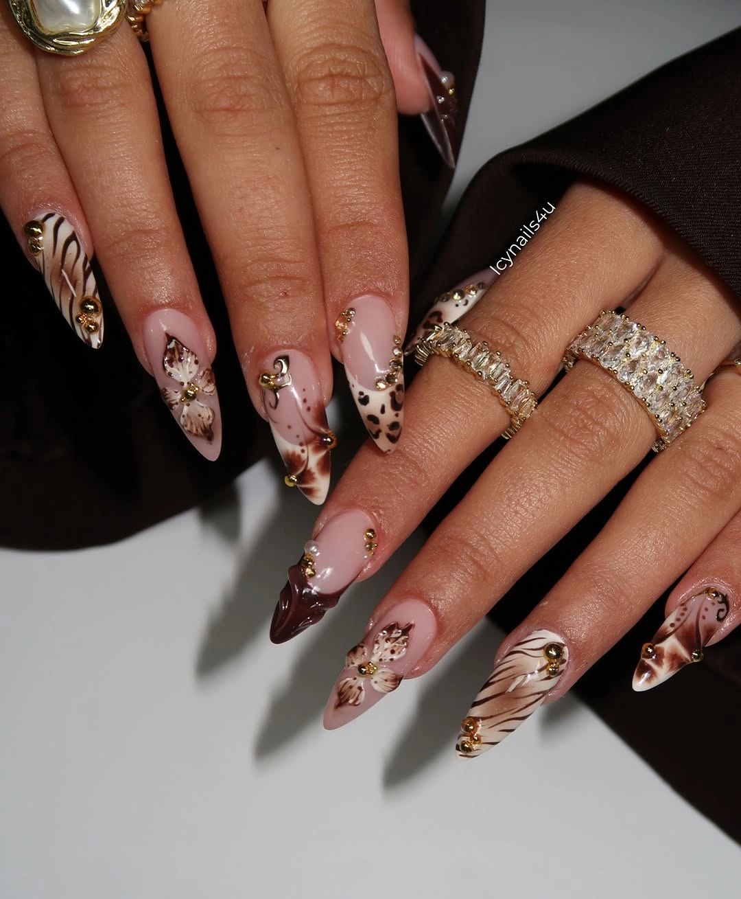 Long pointed brown cream nails with gold accents