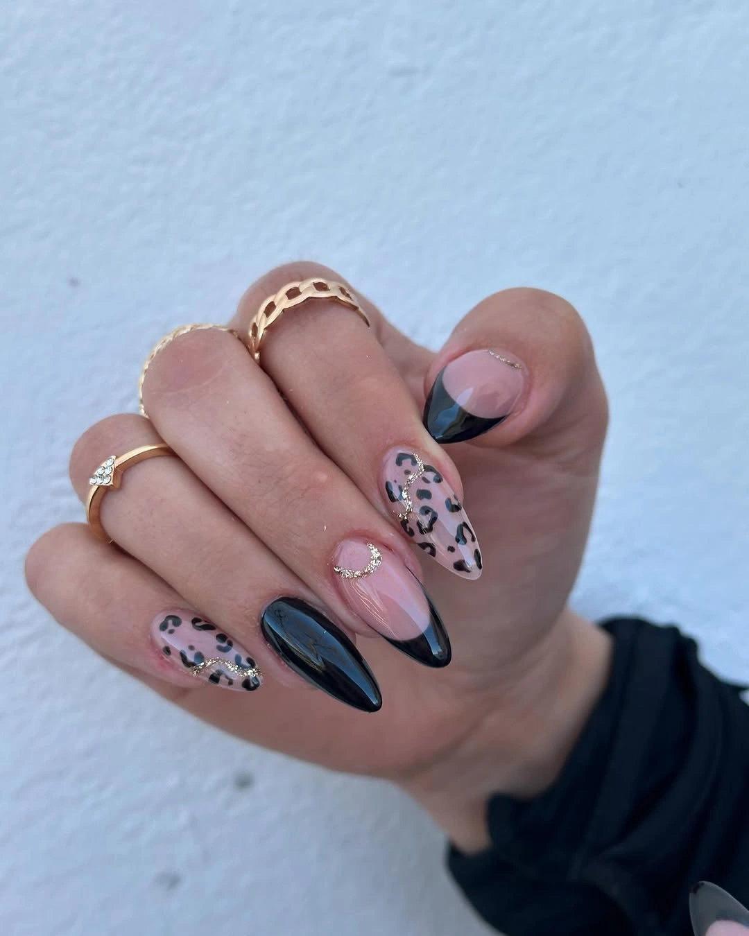 Black French almond nails with animal print accents