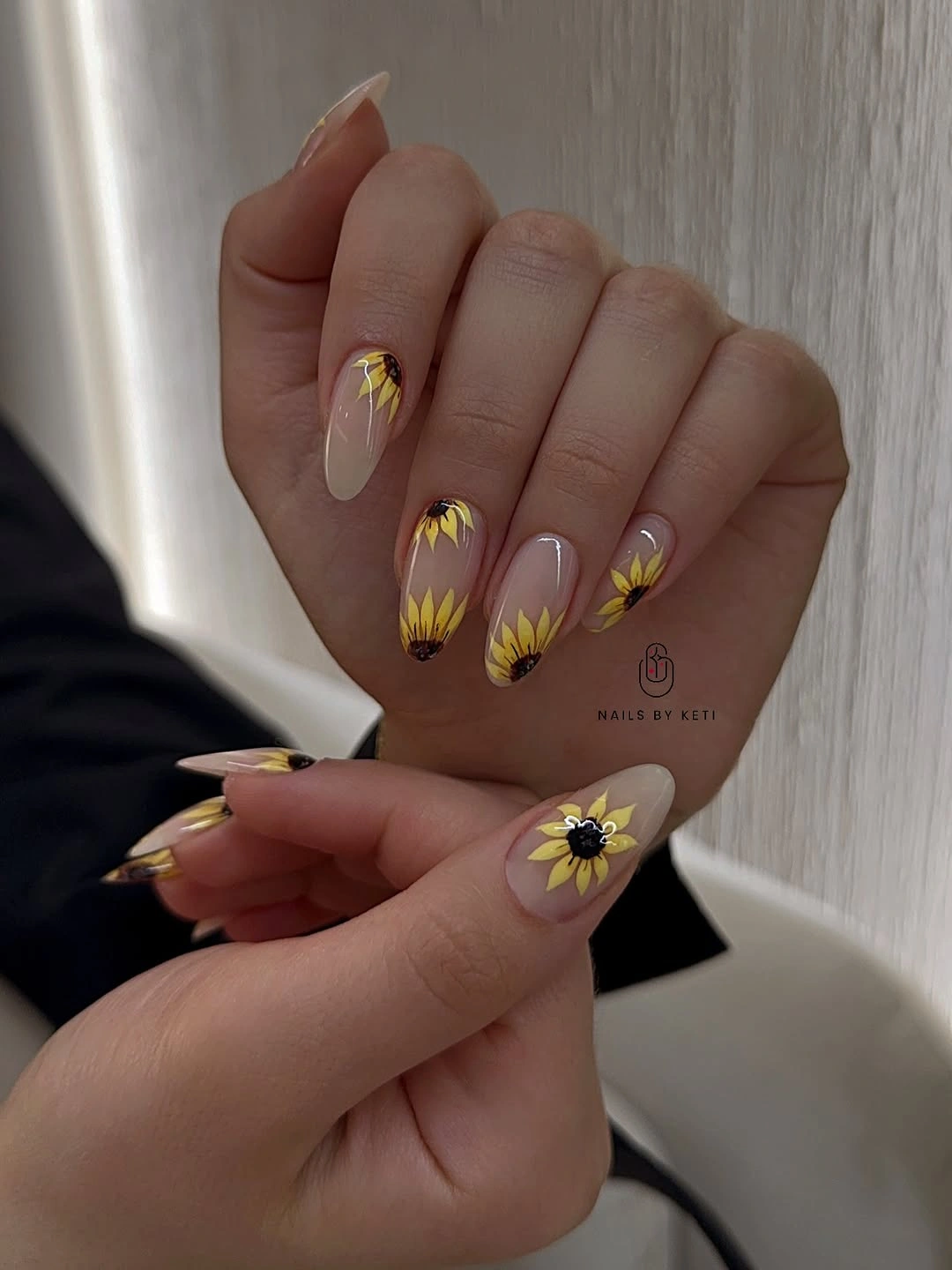 Sheer almond nails with yellow sunflower style petals