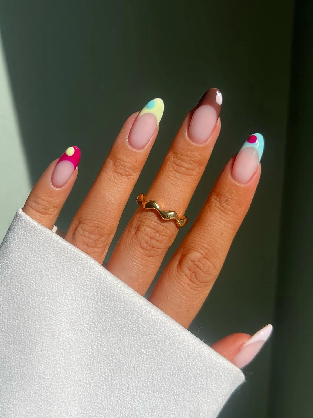 Colorful dotted French tips on sheer almond nails