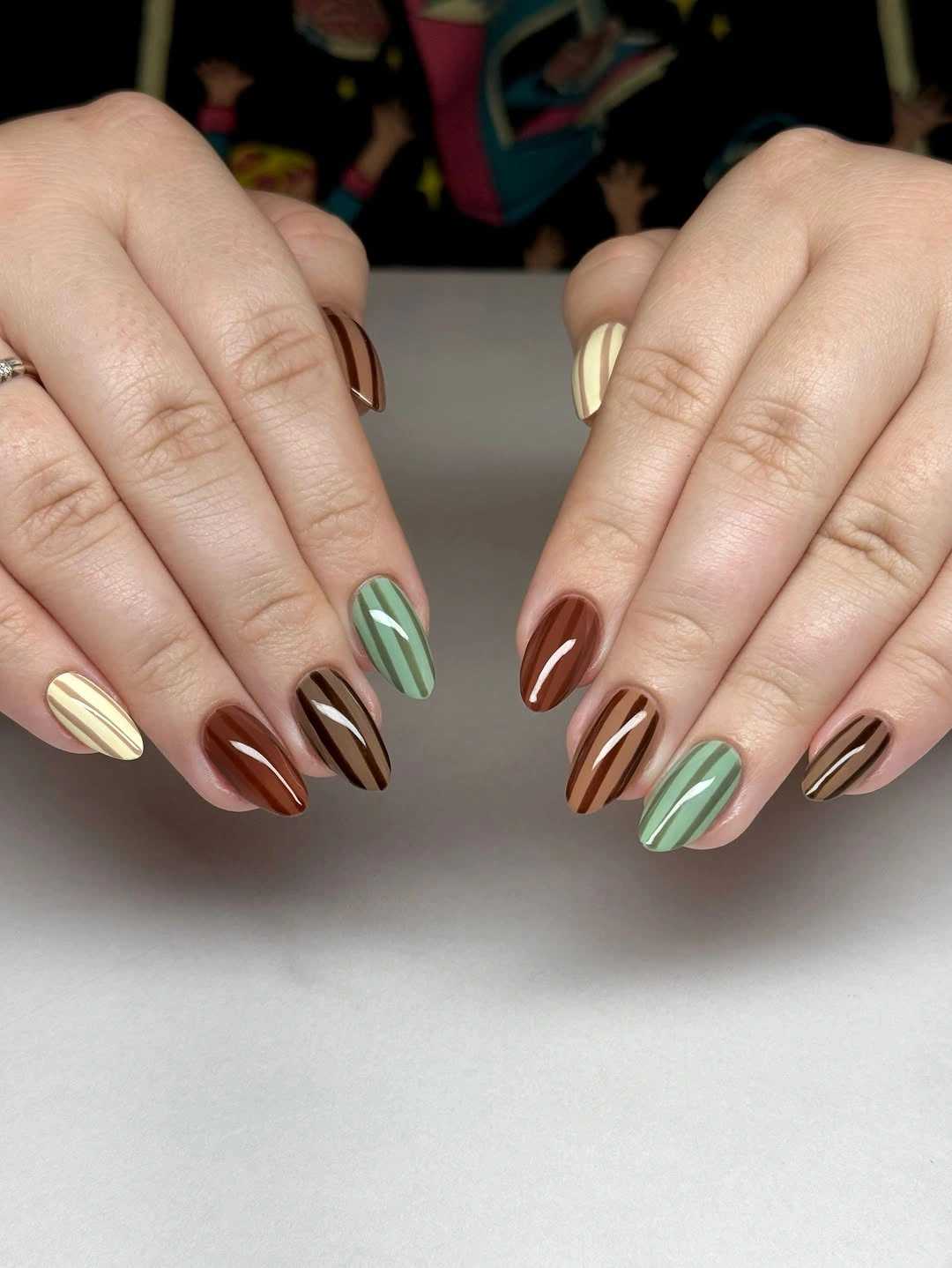 Short almond nails with brown green and cream stripes
