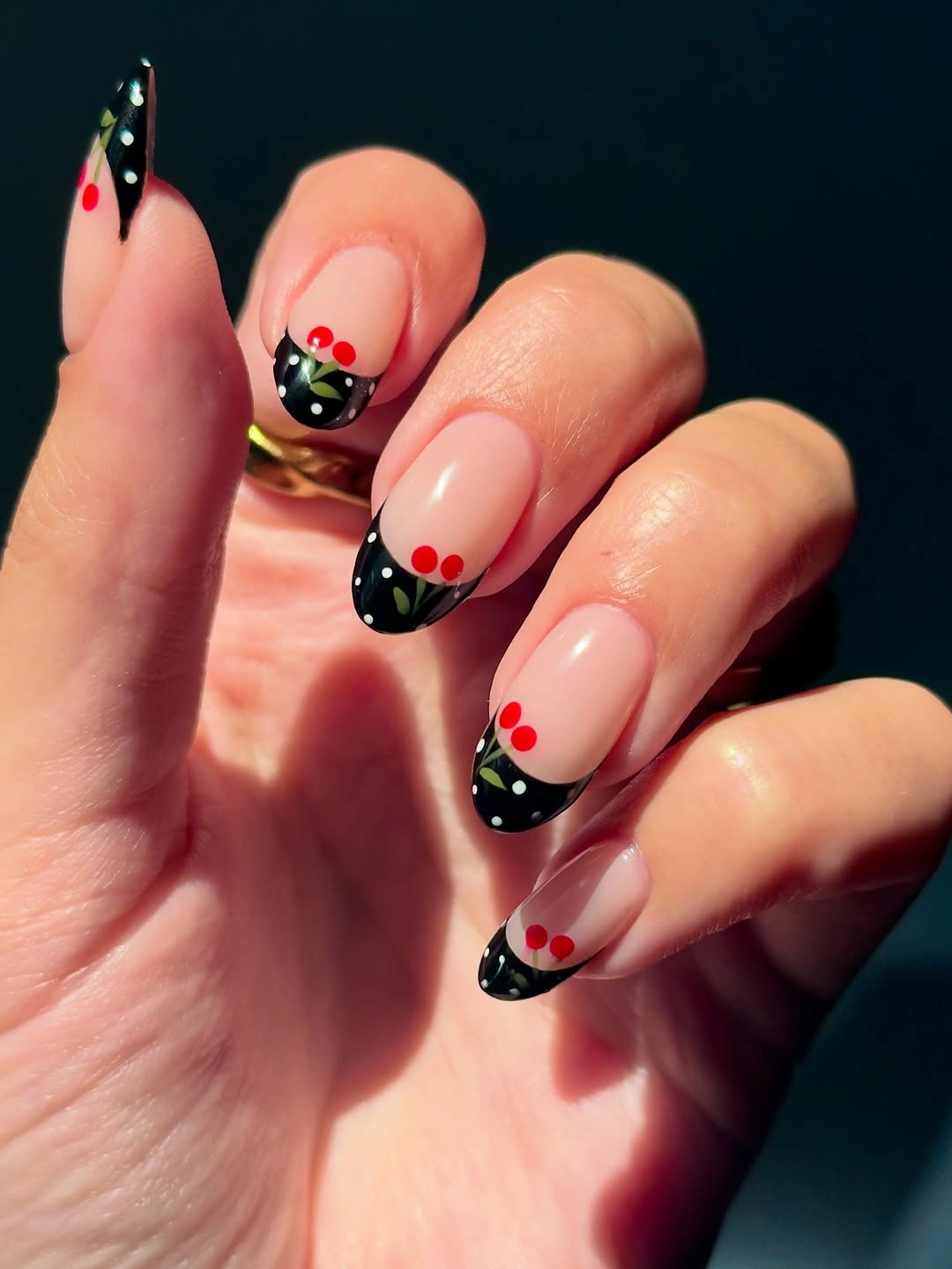 Black dotted French tips with cherry like accents