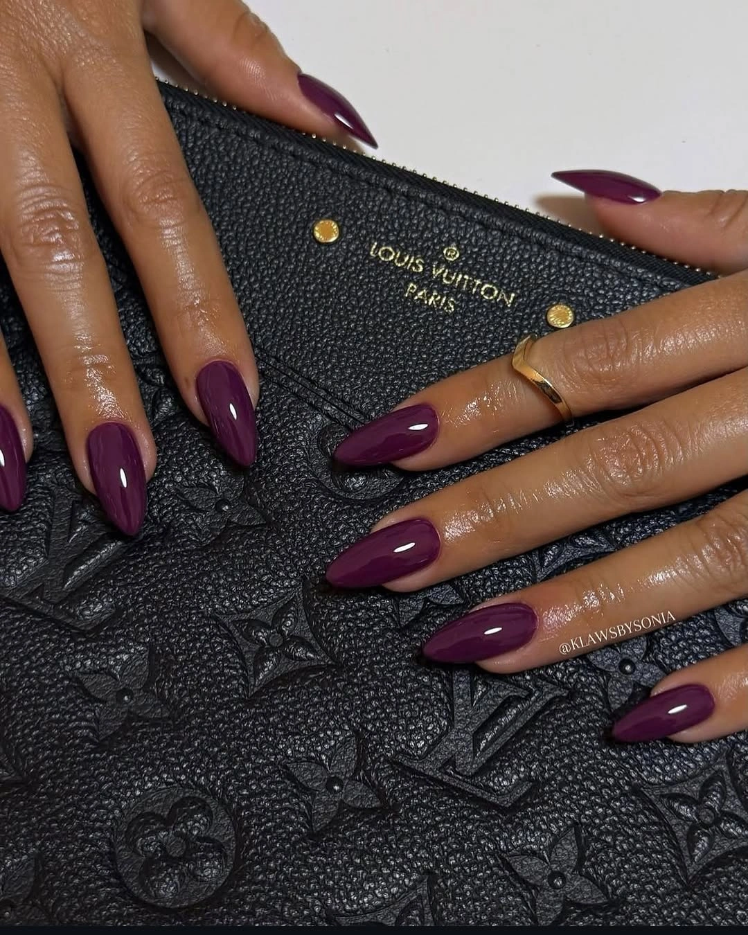 Solid glossy deep plum almond nails