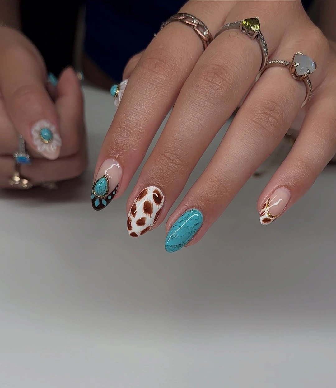 Turquoise and brown spotted almond nail design