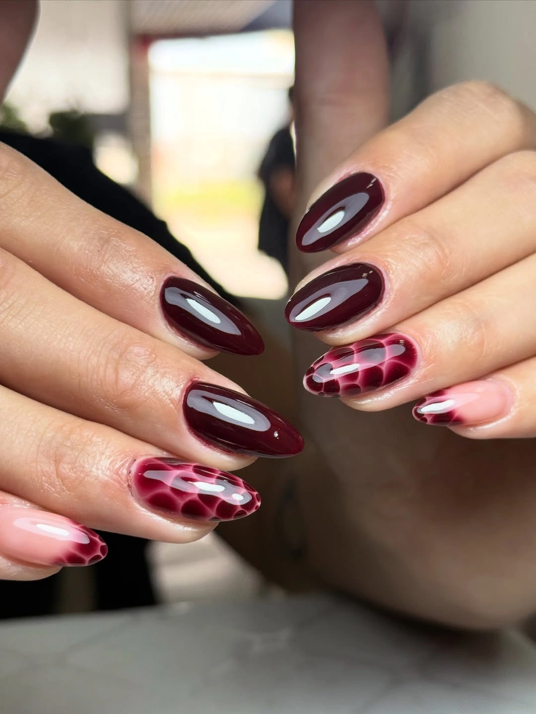Burgundy almond nails with smoky pink accents