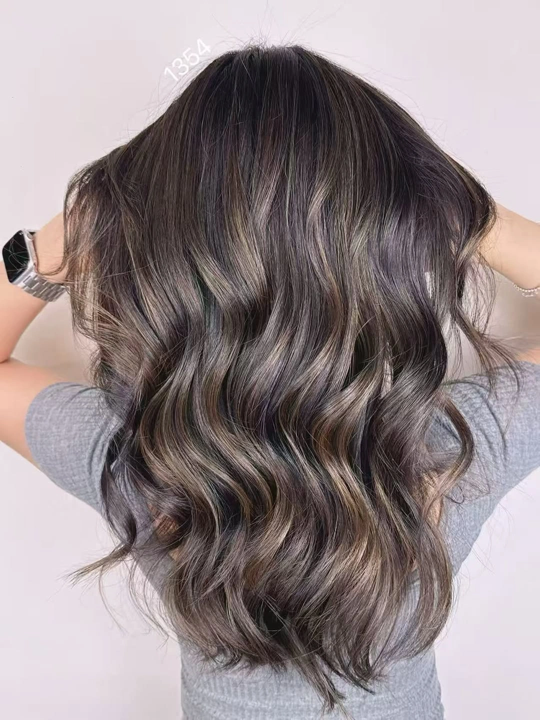 Long cool brown waves with lighter ribbons through the surface