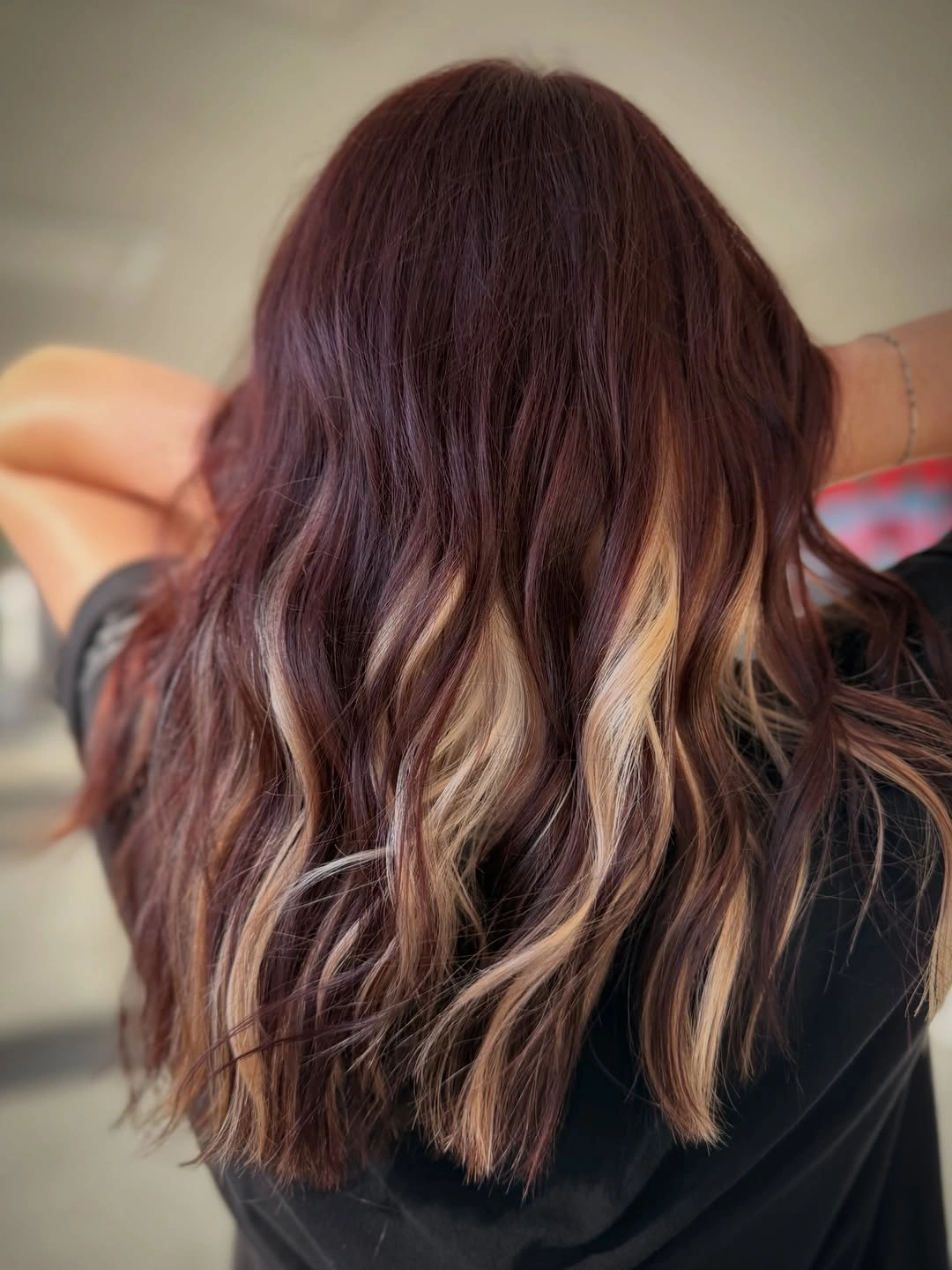 Long deep auburn brown hair with lighter copper strands at the ends